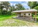 Exterior view of the shed featuring a large shelter and white siding, under a clear blue sky at 2360 Mooneyham Dr, New Smyrna Beach, FL 32168