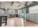 Spacious workshop with ample workbenches, windows, corrugated metal walls and durable laminate flooring at 2360 Mooneyham Dr, New Smyrna Beach, FL 32168