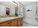 Bathroom featuring a vanity, mirror, shower, tub combo, and natural light from a window at 258 W Sabal Palm Pl # 22, Longwood, FL 32779