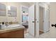 Bathroom view showing a vanity, with a bedroom visible, and a closet door offering storage options at 258 W Sabal Palm Pl # 22, Longwood, FL 32779