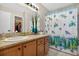 Bathroom featuring a vanity, mirror, tub/shower, and colorful decor at 258 W Sabal Palm Pl # 22, Longwood, FL 32779