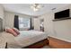 Bedroom featuring wood floors, a TV, and a comfortable layout with an ensuite bathroom at 258 W Sabal Palm Pl # 22, Longwood, FL 32779