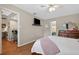 Bedroom with wood floors, a mounted TV, and entry to the kitchen and bathroom at 258 W Sabal Palm Pl # 22, Longwood, FL 32779
