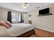 Bedroom featuring wood floors, TV, and plenty of sunlight at 258 W Sabal Palm Pl # 22, Longwood, FL 32779
