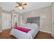 Comfortable bedroom with a queen bed, ceiling fan, and access to the bathroom at 258 W Sabal Palm Pl # 22, Longwood, FL 32779