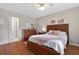 Comfortable bedroom with an ensuite bath, wood floors, and soothing wall art at 258 W Sabal Palm Pl # 22, Longwood, FL 32779
