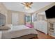 Cozy bedroom bathed in natural light, featuring a queen bed, dresser, and an inviting atmosphere at 258 W Sabal Palm Pl # 22, Longwood, FL 32779