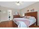Cozy bedroom featuring a wooden bed frame, modern dresser, and ensuite bathroom access at 258 W Sabal Palm Pl # 22, Longwood, FL 32779