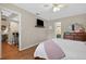 Inviting bedroom showcasing a queen bed, mounted TV, access to the bathroom, and ample space at 258 W Sabal Palm Pl # 22, Longwood, FL 32779