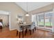 Bright dining area with ample sunlight, wood floors, seating for four, and vaulted ceilings at 258 W Sabal Palm Pl # 22, Longwood, FL 32779