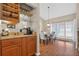 Dining room with hardwood floors, modern light fixture, and natural light from the windows at 258 W Sabal Palm Pl # 22, Longwood, FL 32779