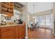 Dining room with hardwood floors, modern light fixture, and natural light from the windows at 258 W Sabal Palm Pl # 22, Longwood, FL 32779