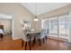 Bright dining area with ample sunlight, wood floors, seating for four, and vaulted ceilings at 258 W Sabal Palm Pl # 22, Longwood, FL 32779