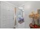 Bright entryway featuring a white door, tile flooring, and a view of the dining area at 258 W Sabal Palm Pl # 22, Longwood, FL 32779