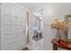 Bright entryway featuring a white door, tile flooring, and a view of the dining area at 258 W Sabal Palm Pl # 22, Longwood, FL 32779