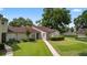 Charming home with well-manicured lawn, complemented by a tiled roof and mature landscaping at 258 W Sabal Palm Pl # 22, Longwood, FL 32779