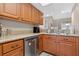 Well-lit kitchen featuring granite countertops, stainless steel appliances, and wooden cabinets at 258 W Sabal Palm Pl # 22, Longwood, FL 32779