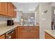 Well-lit kitchen featuring granite countertops, stainless steel appliances, and wooden cabinets at 258 W Sabal Palm Pl # 22, Longwood, FL 32779