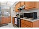 Kitchen featuring granite countertops, modern appliances, and wooden cabinetry at 258 W Sabal Palm Pl # 22, Longwood, FL 32779