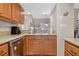 Cozy kitchen featuring granite countertops, stainless steel appliances, and wooden cabinets at 258 W Sabal Palm Pl # 22, Longwood, FL 32779