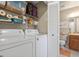 Functional laundry area with storage, washer, dryer, and close proximity to the bathroom at 258 W Sabal Palm Pl # 22, Longwood, FL 32779
