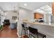 View from breakfast bar into living room with vaulted ceilings and wood floors at 258 W Sabal Palm Pl # 22, Longwood, FL 32779