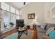 Inviting living room with large windows, comfortable seating, wood floors, and natural light at 258 W Sabal Palm Pl # 22, Longwood, FL 32779