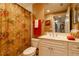 Neutral bathroom featuring a toilet, a white sink cabinet, and a floral shower curtain at 265 Minorca Beach Way # 902, New Smyrna Beach, FL 32169