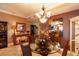 Charming dining room showcasing tile flooring, wicker chairs, a glass table, and a decorative mirror and china cabinet at 265 Minorca Beach Way # 902, New Smyrna Beach, FL 32169