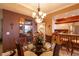 Charming dining room with a chandelier and seating for four, with an adjacent kitchen and bar at 265 Minorca Beach Way # 902, New Smyrna Beach, FL 32169