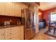 A kitchen with white cabinets, stainless steel appliances, and a view into the dining room at 265 Minorca Beach Way # 902, New Smyrna Beach, FL 32169