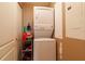 Small laundry closet featuring a stacked washer and dryer with a metal shelf next to it at 265 Minorca Beach Way # 902, New Smyrna Beach, FL 32169