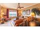 Comfortable living room with modern ceiling fan, leather seating, and large windows offering a scenic view at 265 Minorca Beach Way # 902, New Smyrna Beach, FL 32169