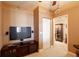 Comfortable living room featuring a large television and an open entryway at 265 Minorca Beach Way # 902, New Smyrna Beach, FL 32169