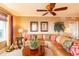 Bright living room featuring a plush leather sofa, tropical decor, and large windows with natural light at 265 Minorca Beach Way # 902, New Smyrna Beach, FL 32169