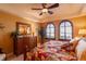 Inviting bedroom with natural light, a dresser, arched windows with shutters, and a ceiling fan at 265 Minorca Beach Way # 902, New Smyrna Beach, FL 32169