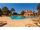 Inviting community pool surrounded by lounge chairs, palm trees, and lush landscaping at 265 Minorca Beach Way # 902, New Smyrna Beach, FL 32169
