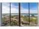 Panoramic view from a high-rise condo showcasing the water, marina, and lush landscape under a clear blue sky at 265 Minorca Beach Way # 902, New Smyrna Beach, FL 32169