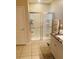This bathroom features a glass shower stall with granite countertops on the vanity and tile floors at 2672 Star Coral Ln, New Smyrna Beach, FL 32168