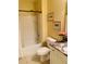 Bright bathroom features a shower and tub combination with a granite vanity and floral decorations at 2672 Star Coral Ln, New Smyrna Beach, FL 32168