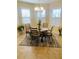 Cozy dining area with a chandelier, bay windows with plantation shutters, and seating for four at 2672 Star Coral Ln, New Smyrna Beach, FL 32168