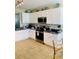 Renovated kitchen with white cabinets, granite countertops, and stainless steel appliances at 2672 Star Coral Ln, New Smyrna Beach, FL 32168