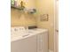 Functional laundry area with washer and dryer, wire shelving, and storage solutions at 2672 Star Coral Ln, New Smyrna Beach, FL 32168