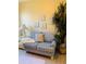 Cozy sitting area with a blue striped love seat, side table, and a floor plant at 2672 Star Coral Ln, New Smyrna Beach, FL 32168