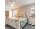 This main bedroom features a leafy bedspread, lots of light, and a fan to keep you comfortable at 2672 Star Coral Ln, New Smyrna Beach, FL 32168