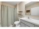 Well-lit bathroom featuring gray vanity, tile flooring, and framed mirror at 2731 Neverland Dr, New Smyrna Beach, FL 32168
