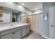 Bright bathroom features double sinks, framed mirror, and walk-in shower at 2731 Neverland Dr, New Smyrna Beach, FL 32168
