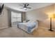 Bright bedroom with carpet, fan, and natural light from the window at 2731 Neverland Dr, New Smyrna Beach, FL 32168