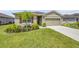 Inviting single-story home featuring a lush green lawn, well-manicured landscaping, and a charming front entrance at 2731 Neverland Dr, New Smyrna Beach, FL 32168