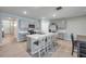 Modern kitchen with gray cabinets, stainless steel appliances, a center island with seating, and neutral tile flooring at 2731 Neverland Dr, New Smyrna Beach, FL 32168